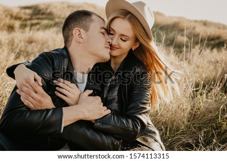 Happy young couple enjoying outdoors during sunset - Image 