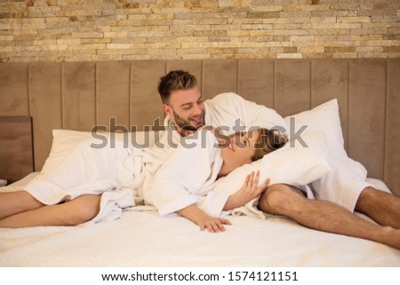 Weekend is just for us. Young couple on bed.