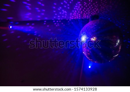 Disco ball with bright rays, night party background photo