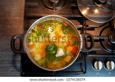 Homemade chicken vegetable soup, overhead, close-up view on a white background. bowl of fresh homemade soup to cure flu at table, top view.
Vegetable soup with ingredients carrot, cauliflower, potato.
