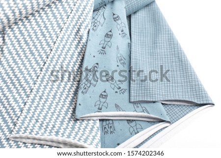fabrics of different shades with a pattern on a white and colored background