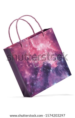 Subject shot of a gift bag with silky plaited handles and with pink and violet abstract design with sparkles and a greetings text: "With love. The best wishes. Wish you happy every day."