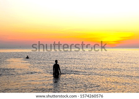 man stood by the sea with his  and watched the sun rise in the morning. He looked happy and warm