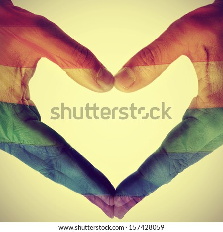picture of man hands forming a hear patterned with the gay pride flag, with a retro effect