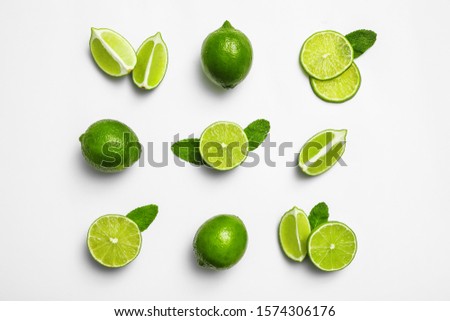 Flat lay composition with fresh juicy limes and mint on white background Royalty-Free Stock Photo #1574306176
