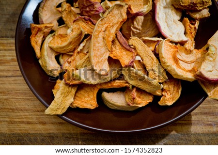 Dried sliced apples, healthy, closeup shot on a wooden surface