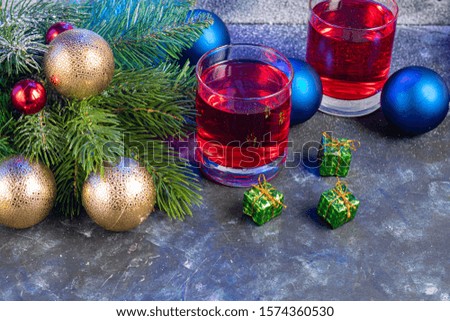 Celebratory drink, rose wine on a dark background. New Year's props, artificial snow. Copy space. 