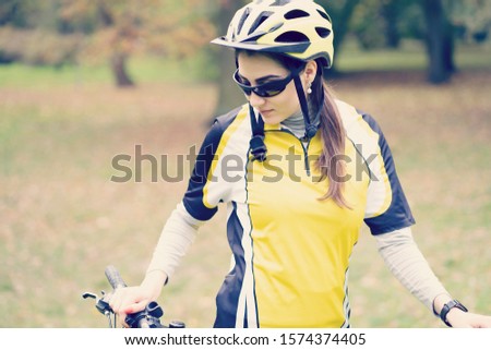 girl athlete in a Bicycle helmet and black glasses