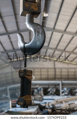 Close up powerful hook crane , industrial plant background. Metal factory. Machine Tool and equipment. Factory background