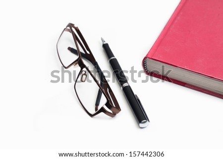 Book pen and Glasses. isolated on whie