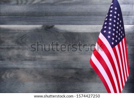 Fragment of the us flag in the foreground blurred light background copy space