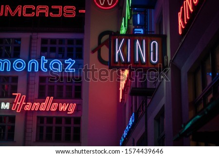 Glow, bright, words in neon light reflected everywhere, on the night in Wroclaw, Poland