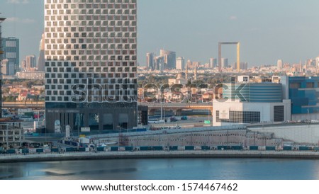 Evening view of the city with Futuristic skyscrapers and monument in Zabeel district aerial timelapse from Business Bay before sunset, Dubai, United Arab Emirates