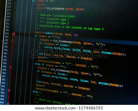 The program for editing the source code of the website - part of the code in php. Colorful code components on a dark background.