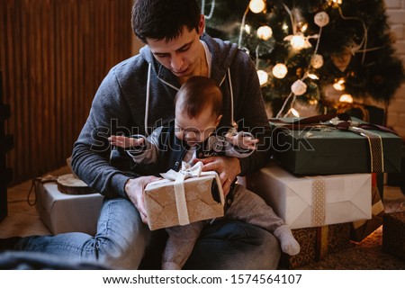Young father and his little son together in a christmas decoration. Man and baby boy together, new year's eve