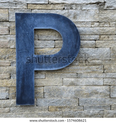 Modern parking sign on a stone wall - sign 