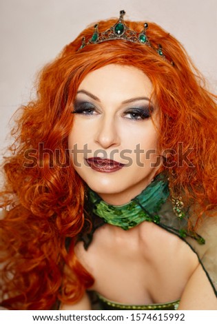 Woman in green medieval fantasy cosplay dress red hair with crown on her head with painterly background