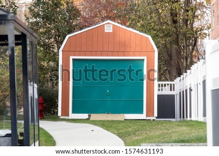 Picture of a single garage door painted in green color.