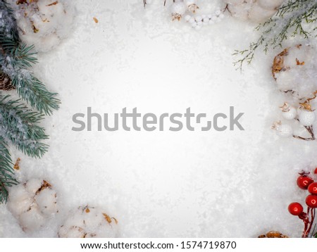Festive winter flat lay. Snow, cones and branches of a green Christmas tree on a white background, copy space in the center, decorative frame on a winter theme