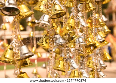 Many beautiful golden christmas bells hanging as new year toys, horizontal picture
