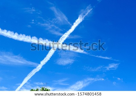 Smoke from a jet plane in the blue sky, perspective angle