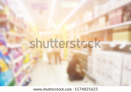 Blurred photo of people shopping in supermarket in black Friday 