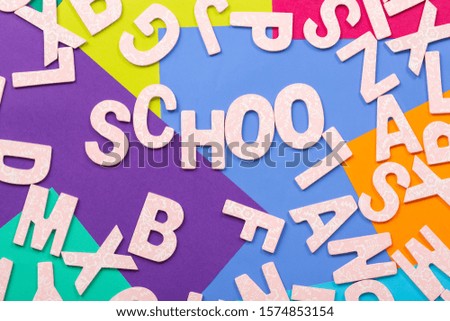 Lots of Alphabets on colorful background with the word School