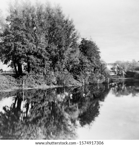 Reflection of trees in the water- This black and white photo is NOT sharp due to camera characteristic. Taken on film with a medium format camera