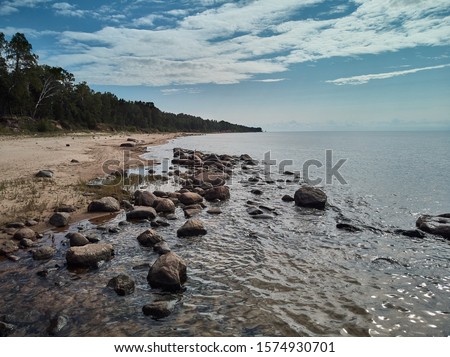 Sea waves lash line impact rock on the beach Royalty-Free Stock Photo #1574930701