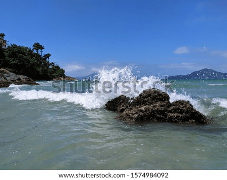 Waves breaking in a rock formation in Praia Vermelha do Centro, Ubatuba, Brazil