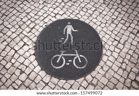 Bicycle and pedestrian lane road sign on the ground in Lisbon, Portugal Royalty-Free Stock Photo #157499072