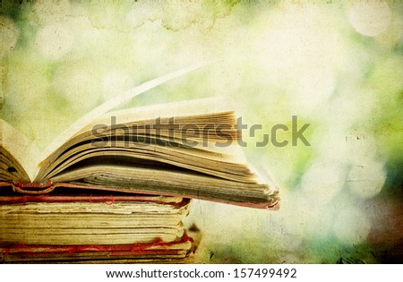 Vintage photo of old books on colorful bokeh background