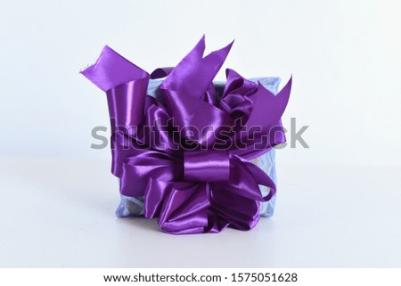 A Christmas gift box purple ribbon