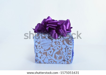 A Christmas gift box purple ribbon