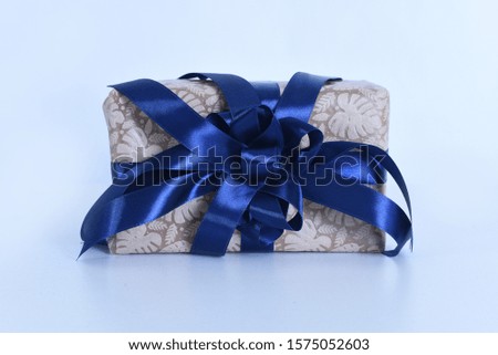 A Christmas gift box blue ribbon