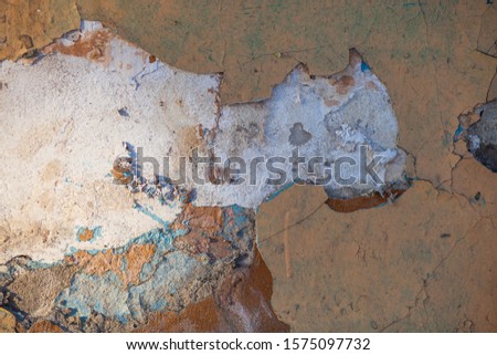 Background. Old and shabby concrete wall. Peeling plaster. Gray-yellow colors.