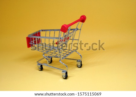 Shopping Cart isolated yellow background - Shopping stores to buy goods concept 