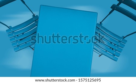 Two blue chairs and table on blue sky background