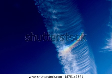 Cloud with rainbow in it