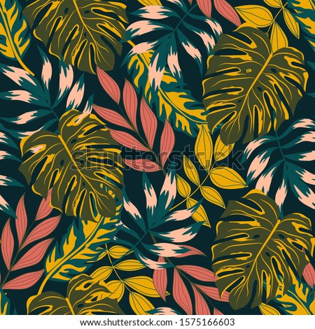 Trending abstract seamless pattern with tropical leaves and bright colors. Jungle seal. Vector design. The background floral. Textiles and printing. Exotic, tropical.