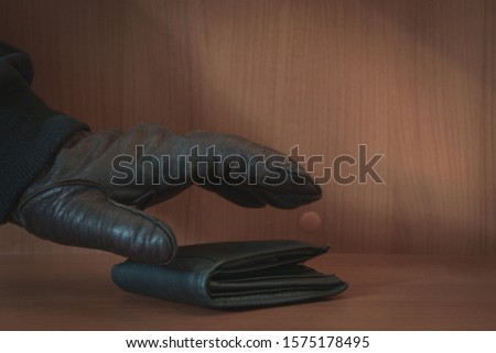 Thief has your wallet.man hand wallet and money on table