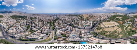 Aerial panoramic drone shot of Athens center with Oplymion Site, Lycabettus hill, acropolis