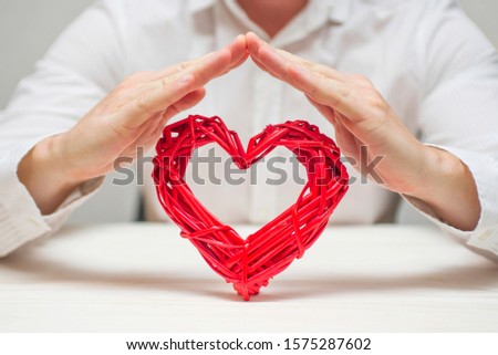 Red heart protected by man hands. Healthcare and medicine concept. Health insurance concept.
