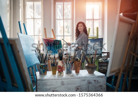 woman artist paint with brushes and oil dye