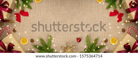 Christmas background with red and green ornaments on linen background. Merry Christmas greeting card, banner. Winter holiday xmas theme. Happy New Year. Space for text