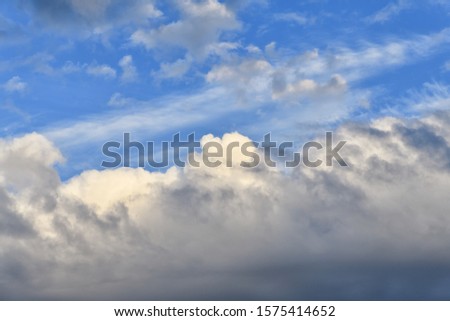 Gloomy beautiful blue sky with clouds on a bright day.  Nature background