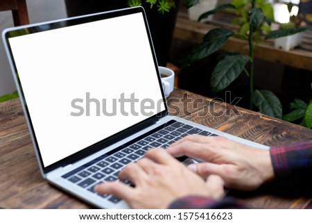 mockup image blank screen computer with white background for advertising text,hand man using laptop contact business search information on desk in office.marketing and design