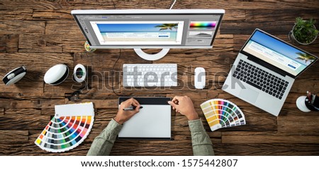 Close-up Of A Designer's Hand Editing Photo On Computer In Office