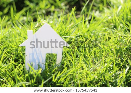 paper house in green grass field