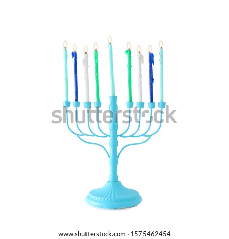 religion image of jewish holiday Hanukkah with blue menorah (traditional candelabra) and colorful candles isolated over white background
